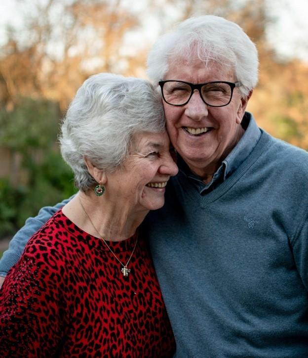Older couple smiling and embracing